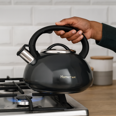 Black kettle with 'Homemax' branding being held over a gas stove.